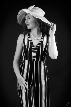 Estella Rose in her own vertical-striped jump suit and straw hat