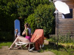 Estella Rose in purple swimsuit exercising in the garden
