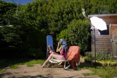Estella Rose in purple swimsuit exercising in the garden