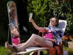 Estella Rose in purple swimsuit exercising in the garden