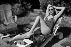 Estella Rose in purple swimsuit exercising in the garden