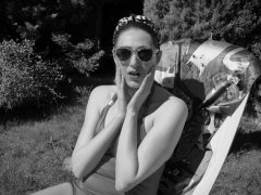 Estella Rose in purple swimsuit exercising in the garden