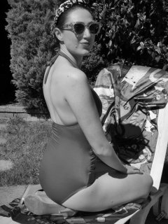 Estella Rose in purple swimsuit exercising in the garden