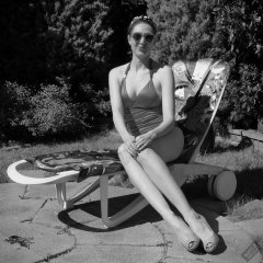 Estella Rose in purple swimsuit exercising in the garden