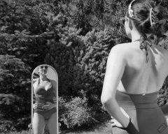 Estella Rose in purple swimsuit exercising in the garden