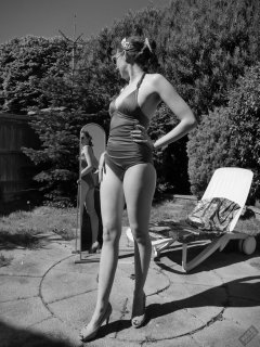 Estella Rose in purple swimsuit exercising in the garden