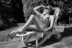 Estella Rose in purple swimsuit exercising in the garden