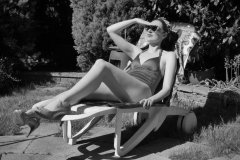 Estella Rose in purple swimsuit exercising in the garden
