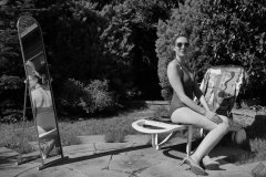 Estella Rose in purple swimsuit exercising in the garden