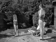 Estella Rose in purple swimsuit exercising in the garden