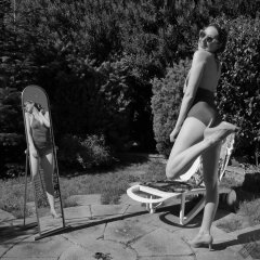 Estella Rose in purple swimsuit exercising in the garden