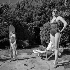 Estella Rose in purple swimsuit exercising in the garden