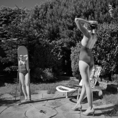 Estella Rose in purple swimsuit exercising in the garden