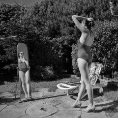 Estella Rose in purple swimsuit exercising in the garden