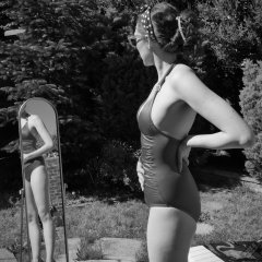 Estella Rose in purple swimsuit exercising in the garden