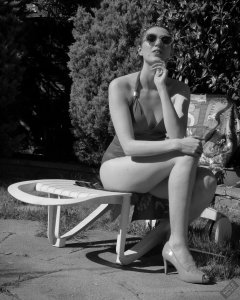 Estella Rose in purple swimsuit exercising in the garden