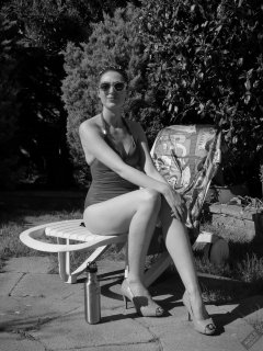Estella Rose in purple swimsuit exercising in the garden