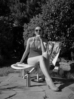 Estella Rose in purple swimsuit exercising in the garden