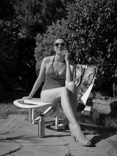 Estella Rose in purple swimsuit exercising in the garden