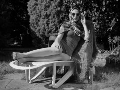 Estella Rose in purple swimsuit exercising in the garden