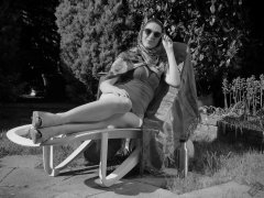 Estella Rose in purple swimsuit exercising in the garden