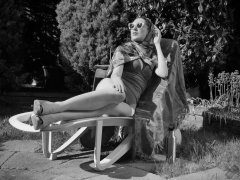 Estella Rose in purple swimsuit exercising in the garden