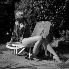 Estella Rose in purple swimsuit exercising in the garden