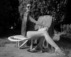 Estella Rose in purple swimsuit exercising in the garden