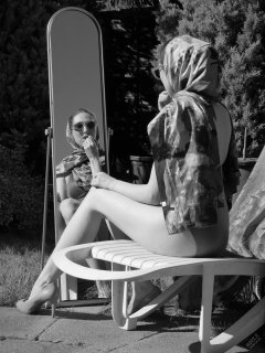 Estella Rose in purple swimsuit exercising in the garden
