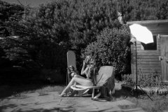 Estella Rose in purple swimsuit exercising in the garden