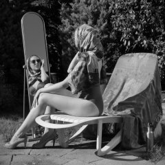 Estella Rose in purple swimsuit exercising in the garden
