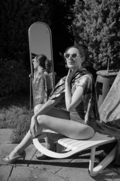 Estella Rose in purple swimsuit exercising in the garden