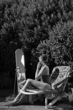 Estella Rose in purple swimsuit exercising in the garden