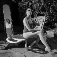Estella Rose in purple swimsuit exercising in the garden