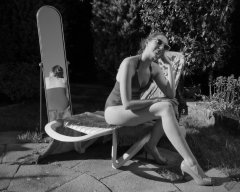 Estella Rose in purple swimsuit exercising in the garden