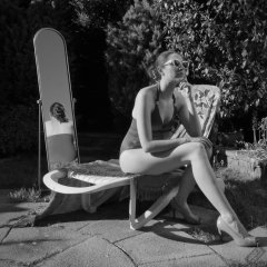 Estella Rose in purple swimsuit exercising in the garden