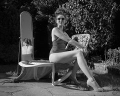 Estella Rose in purple swimsuit exercising in the garden