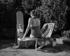 Estella Rose in purple swimsuit exercising in the garden
