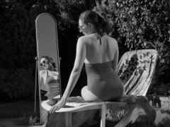 Estella Rose in purple swimsuit exercising in the garden