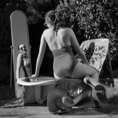 Estella Rose in purple swimsuit exercising in the garden