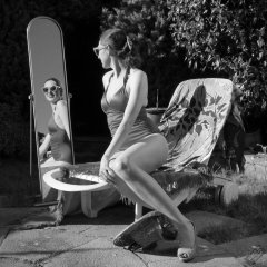 Estella Rose in purple swimsuit exercising in the garden