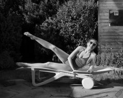 Estella Rose in purple swimsuit exercising in the garden
