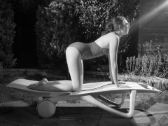 Estella Rose in purple swimsuit exercising in the garden