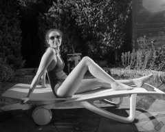 Estella Rose in purple swimsuit exercising in the garden