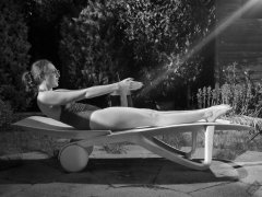 Estella Rose in purple swimsuit exercising in the garden