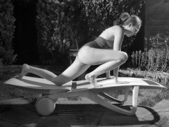 Estella Rose in purple swimsuit exercising in the garden