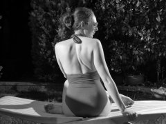 Estella Rose in purple swimsuit exercising in the garden