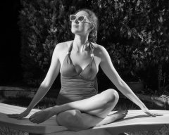 Estella Rose in purple swimsuit exercising in the garden