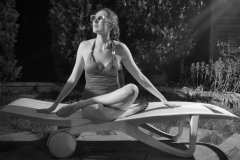 Estella Rose in purple swimsuit exercising in the garden