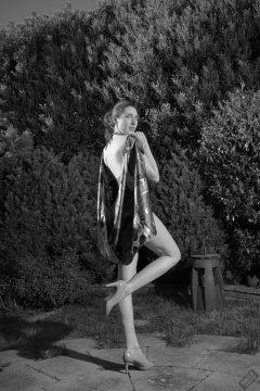 Estella Rose in purple swimsuit exercising in the garden